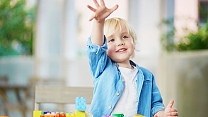Kindergärten / Schulen - Junge spielt mit Plastikbausteinen